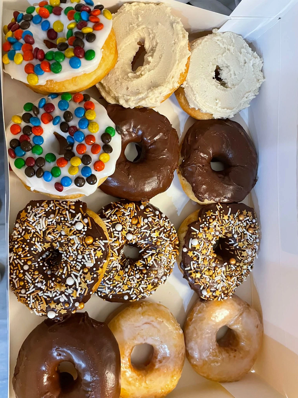 A dozen donuts including maple frosting