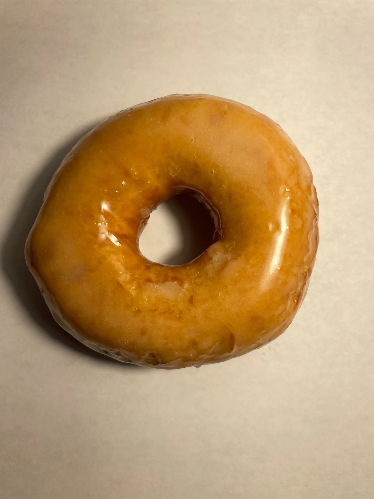 Glazed raised donut viewed from above