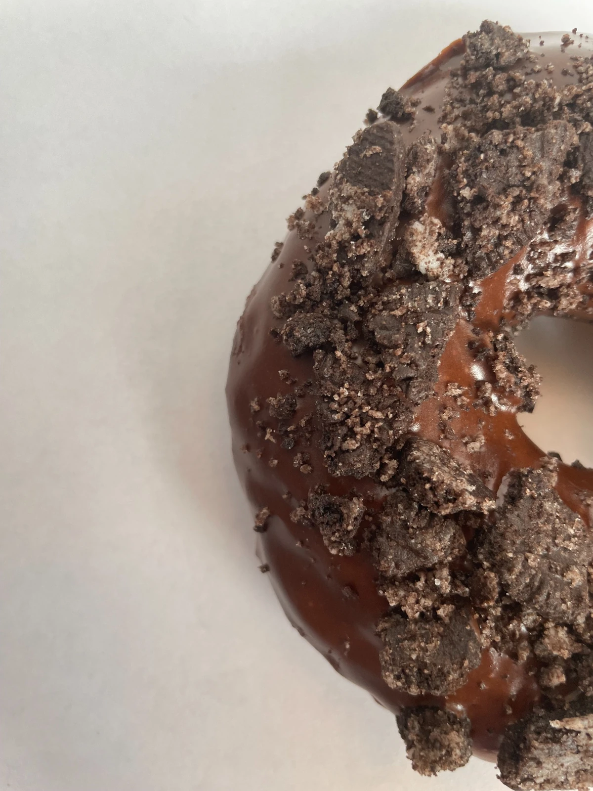 Raised donuts with chocolate icing and Oreo topping