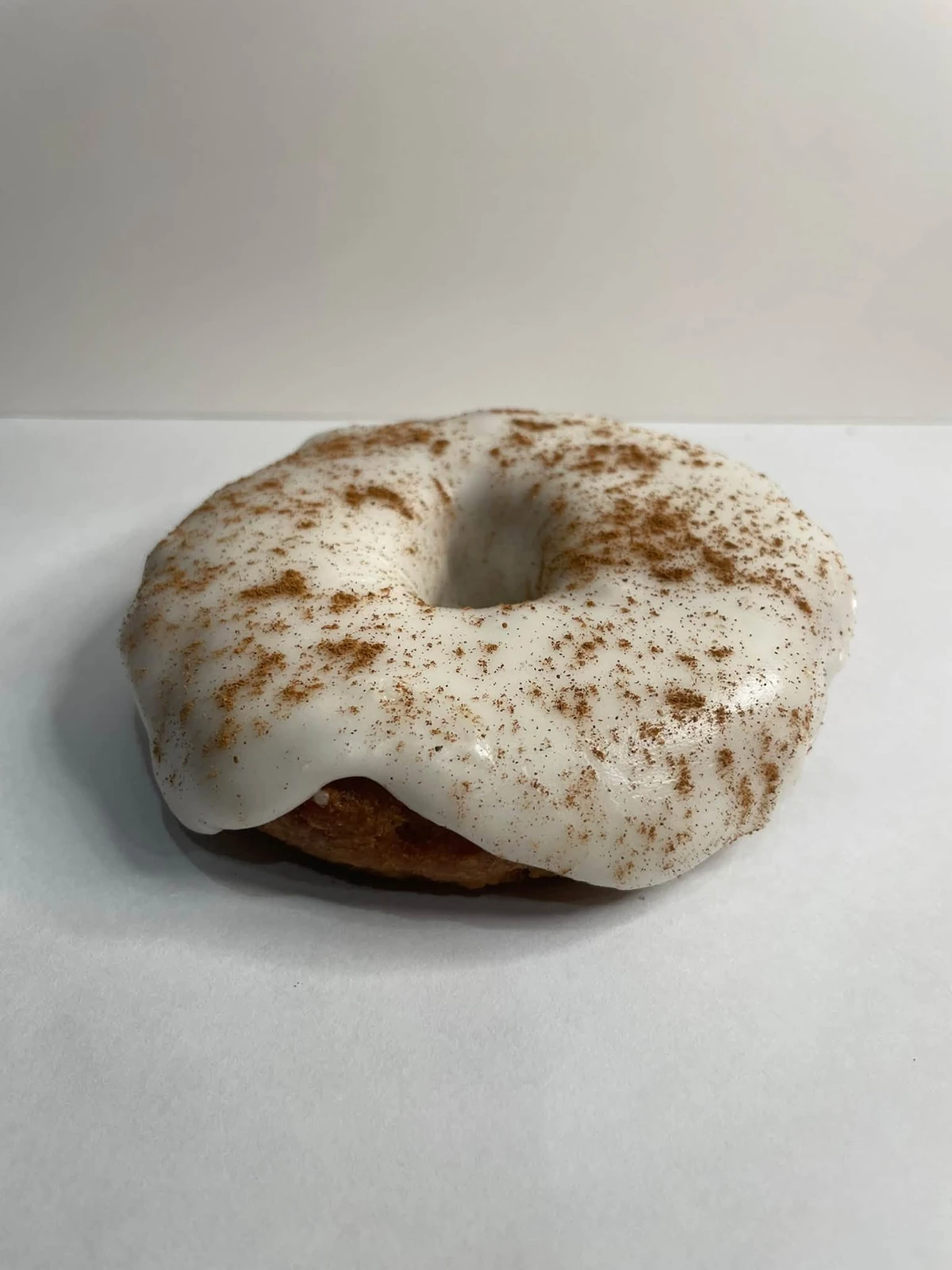 Pumpkin spice cake donut with vanilla frosting and pumpkin spice