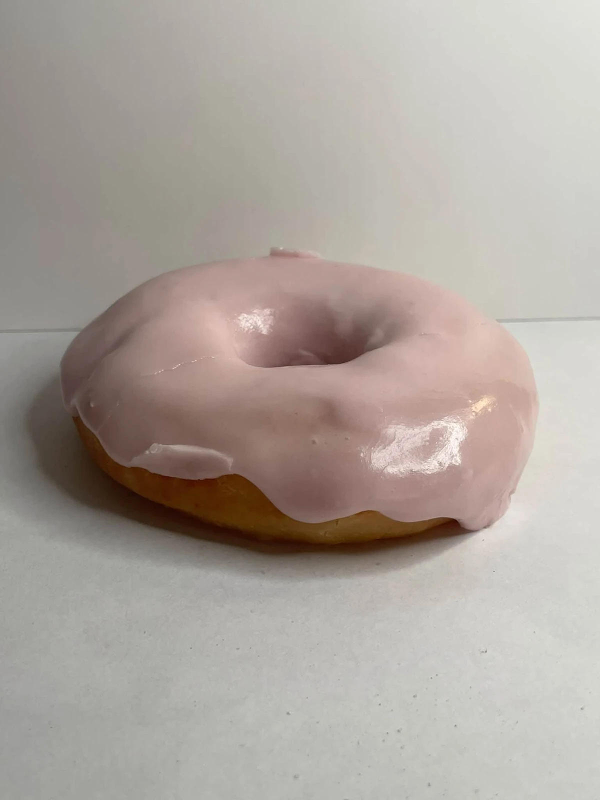 Strawberry frosted raised donut